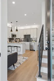 a kitchen with stainless steel appliances kitchen island granite countertop a stove a sink and a refrigerator