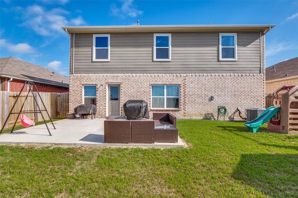 125 Sammy Venus, TX 76084 - Photo 34 of 39 Rear exterior with a concrete patio and a grassy yard