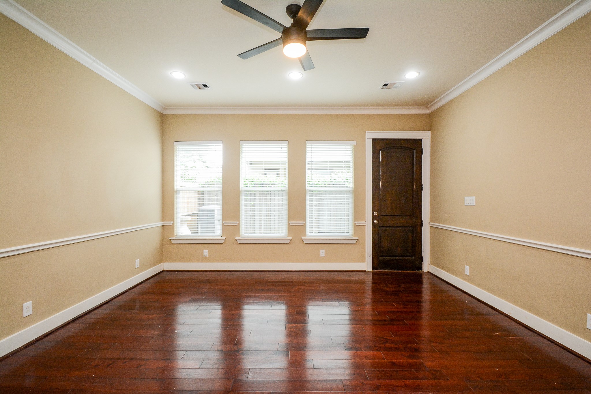 1514 Prince Street Houston, TX 77008 - Photo 5 of 20 an empty room with wooden floor and windows with curtains