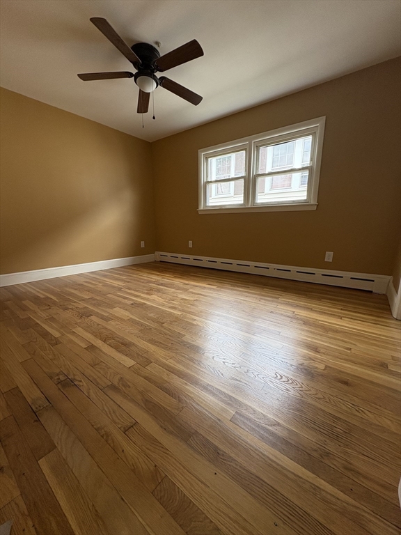 764 Hancock Street, Unit 2 Quincy, MA 02170 - Photo 4 of 6 a view of an empty room with window and wooden floor