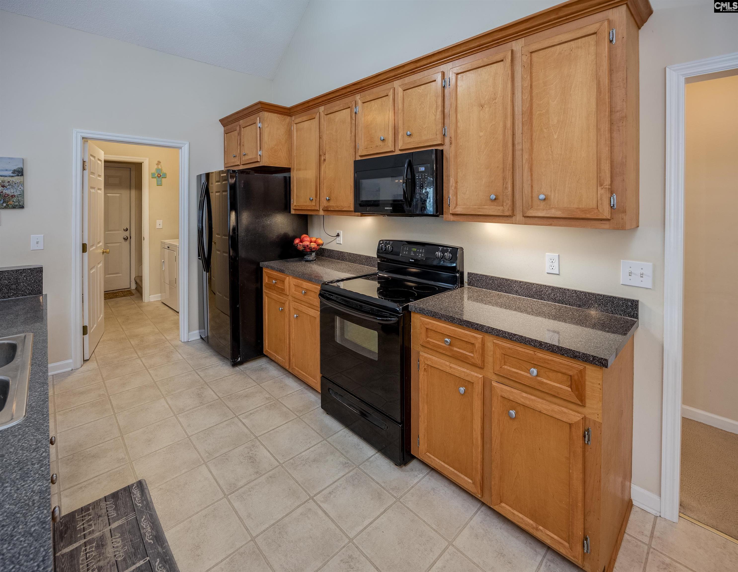 2032 Ridgeway Road Lugoff, SC 29078 - Photo 21 of 57 a kitchen with stainless steel appliances granite countertop a stove a refrigerator and a microwave