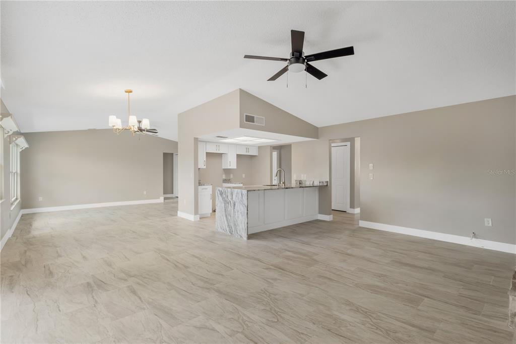 9840 San Sebastian Way Port Richey, FL 34668 - Photo 11 of 45 a view of a kitchen with a sink and a ceiling fan