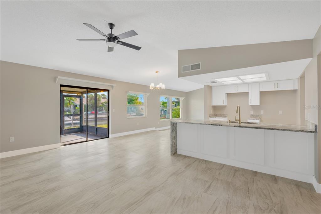 9840 San Sebastian Way Port Richey, FL 34668 - Photo 12 of 45 a view of an empty room with window and wooden floor