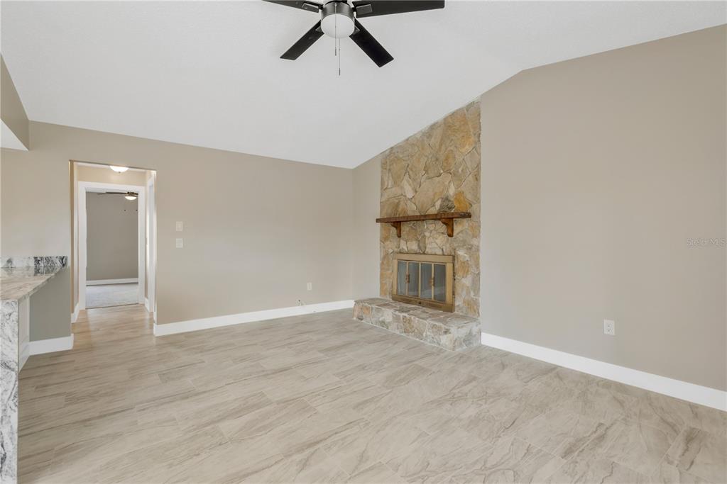 9840 San Sebastian Way Port Richey, FL 34668 - Photo 13 of 45 a view of an empty room with wooden floor