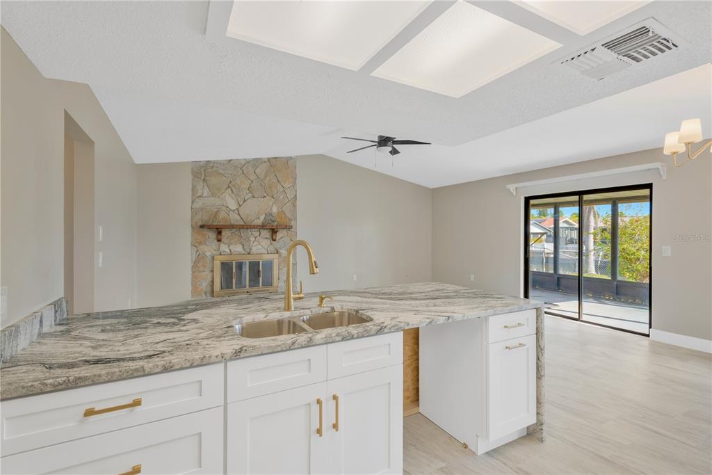 9840 San Sebastian Way Port Richey, FL 34668 - Photo 14 of 45 a kitchen with granite countertop a sink and white cabinets