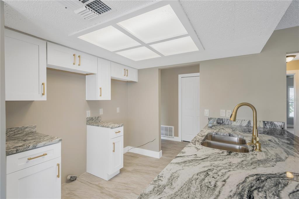 9840 San Sebastian Way Port Richey, FL 34668 - Photo 16 of 45 a bedroom with a bed and a stove top oven