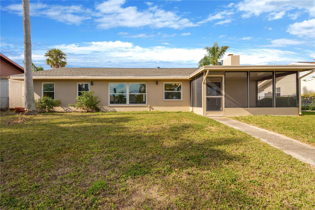9840 San Sebastian Way Port Richey, FL 34668 - Photo 26 of 45 a front view of house with yard outdoor seating and barbeque oven