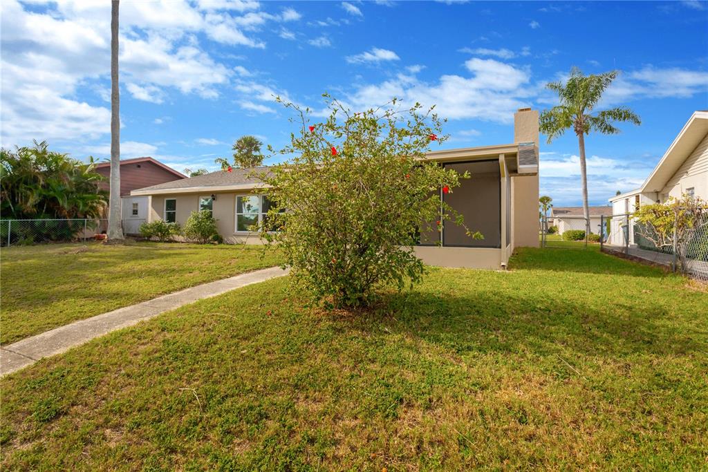 9840 San Sebastian Way Port Richey, FL 34668 - Photo 28 of 45 a front view of a house with a yard