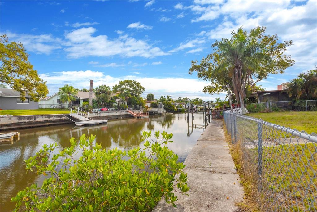 9840 San Sebastian Way Port Richey, FL 34668 - Photo 29 of 45 a view of a lake with houses in the back