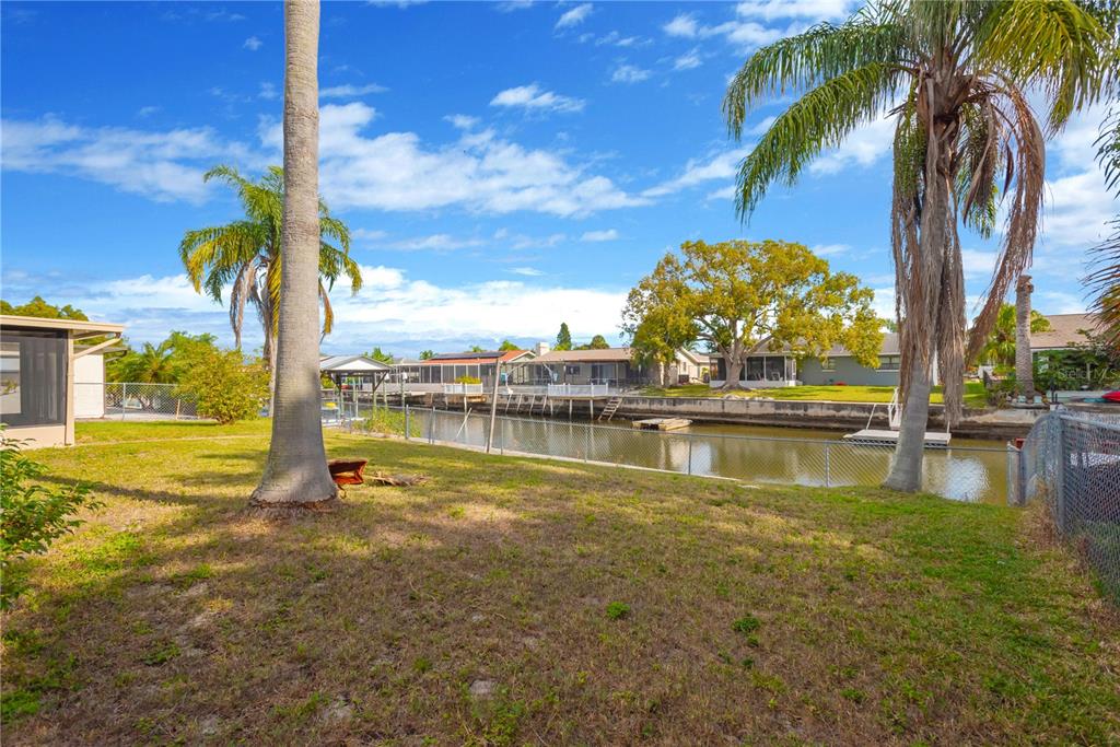 9840 San Sebastian Way Port Richey, FL 34668 - Photo 31 of 45 a view of a lake with a palm trees