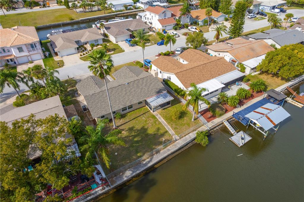9840 San Sebastian Way Port Richey, FL 34668 - Photo 33 of 45 an aerial view of a house with a garden and lake view