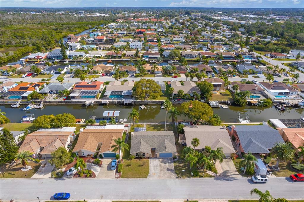 9840 San Sebastian Way Port Richey, FL 34668 - Photo 41 of 45 an aerial view of a houses with a swimming pool