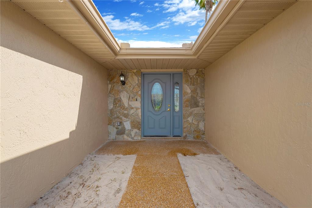 9840 San Sebastian Way Port Richey, FL 34668 - Photo 5 of 45 a view of a hallway with wooden floor and a fireplace