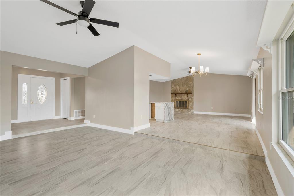 9840 San Sebastian Way Port Richey, FL 34668 - Photo 9 of 45 a view of empty room with wooden floor and window