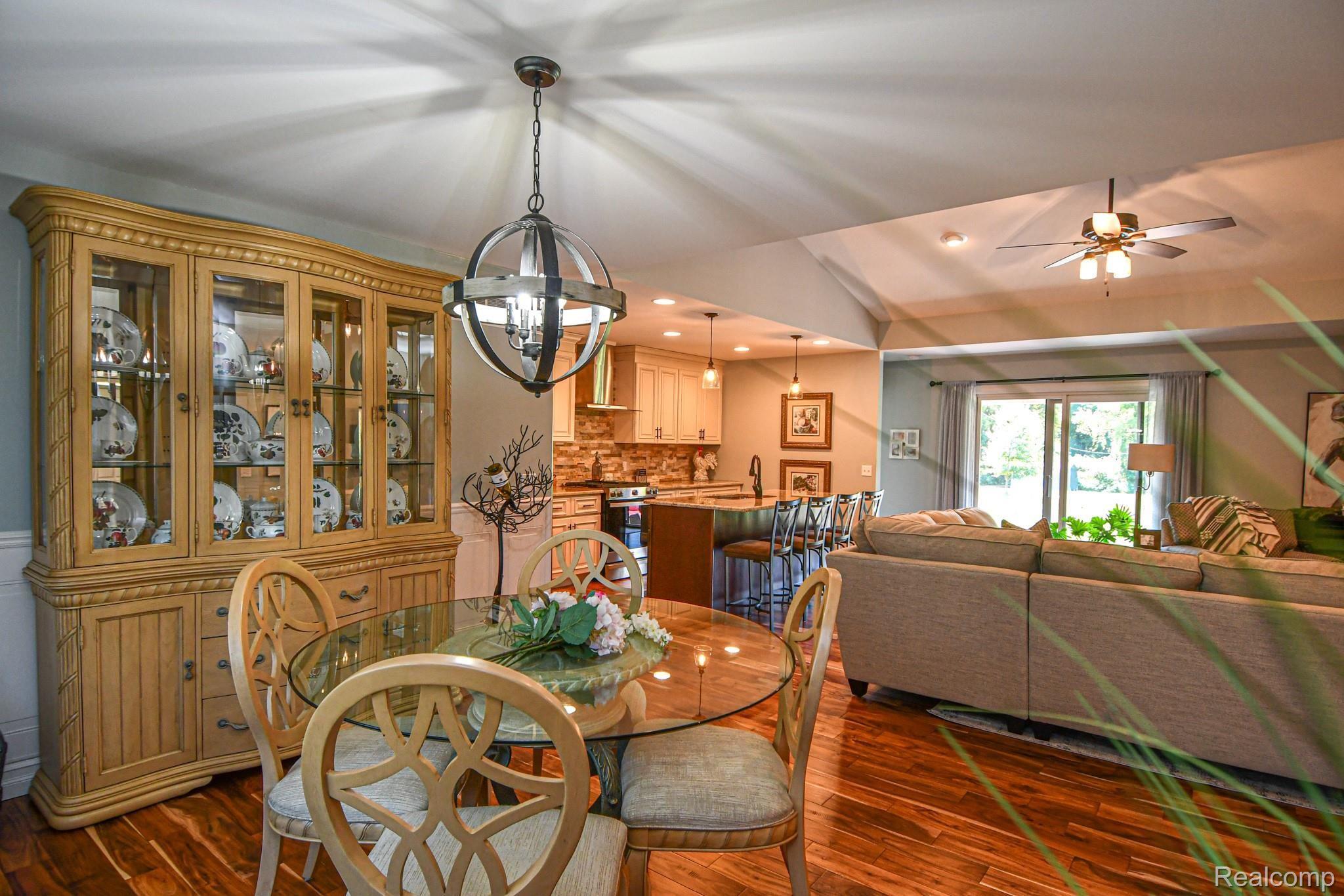 10122 Bennett Lake Road Fenton, MI 48430 - Photo 11 of 56 This open concept Dining area/Living Room/Kitchen has gorgeous Acacia wood floors throughout!