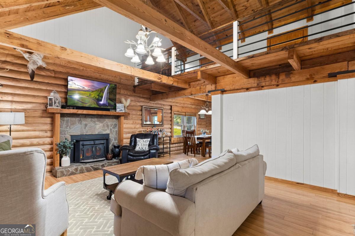 224 Loch Way Eatonton, GA 31024 - Photo 19 of 59 a living room with furniture a fireplace and a flat screen tv