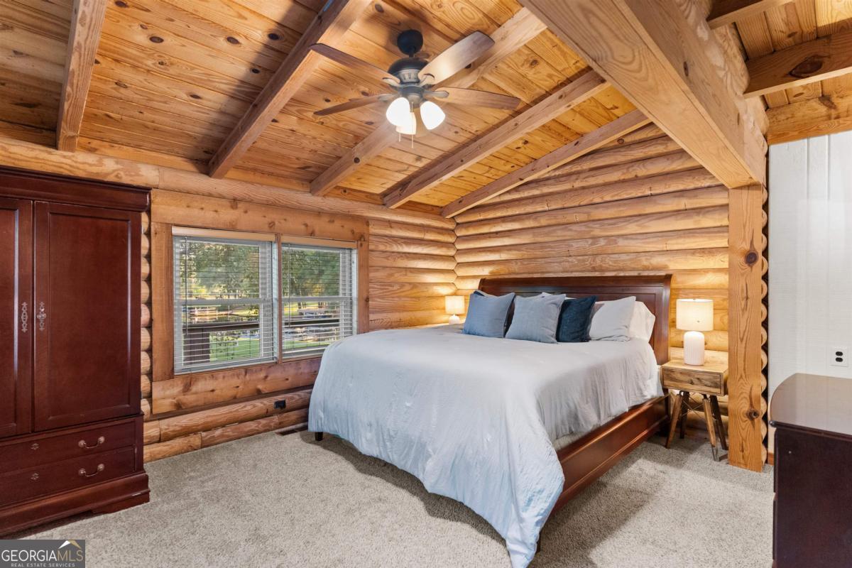 224 Loch Way Eatonton, GA 31024 - Photo 22 of 59 a bedroom with a bed and wooden floor