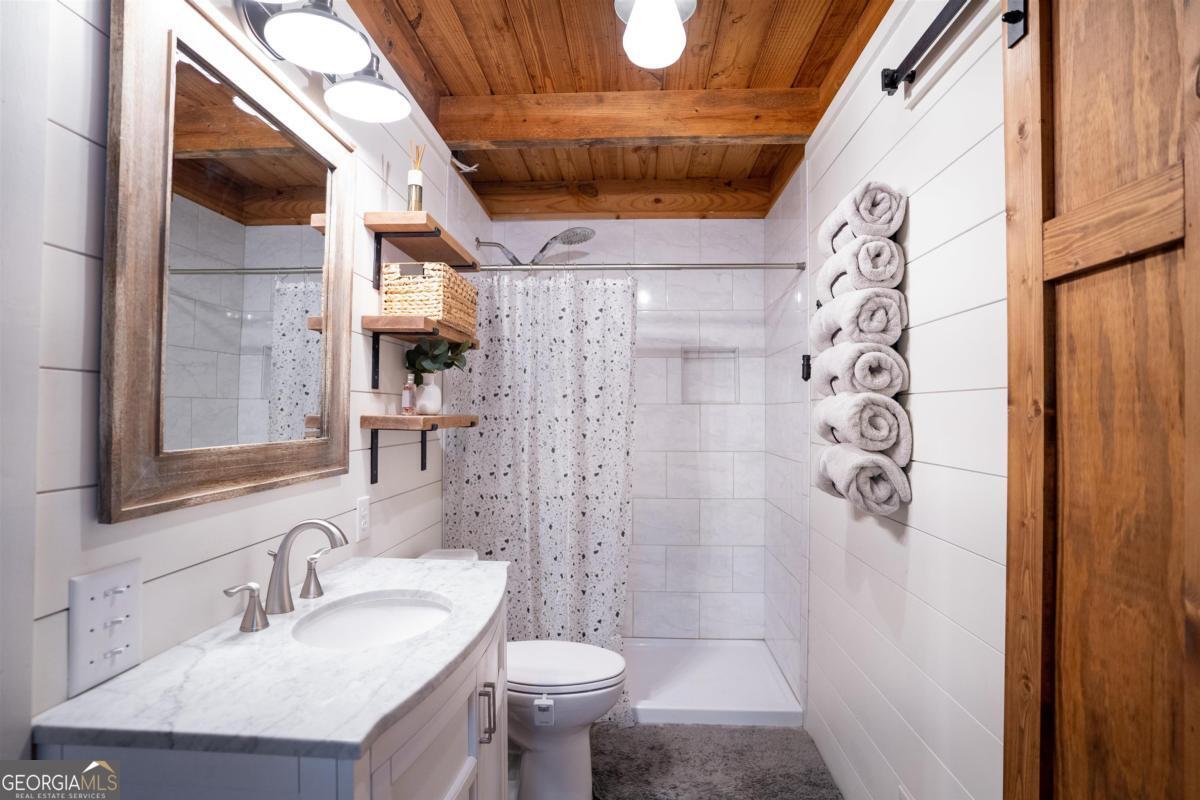 224 Loch Way Eatonton, GA 31024 - Photo 23 of 59 a bathroom with a sink and toilet