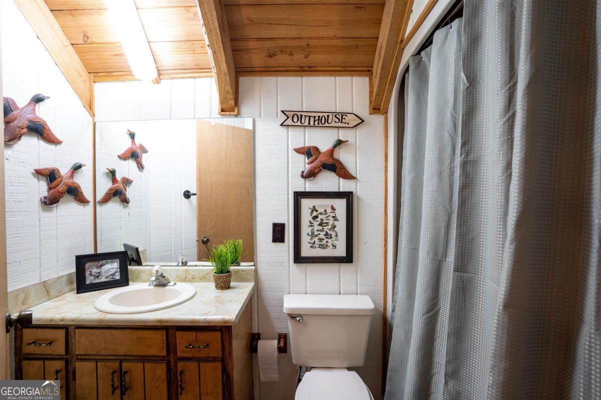 224 Loch Way Eatonton, GA 31024 - Photo 27 of 59 a bathroom with a toilet sink and mirror