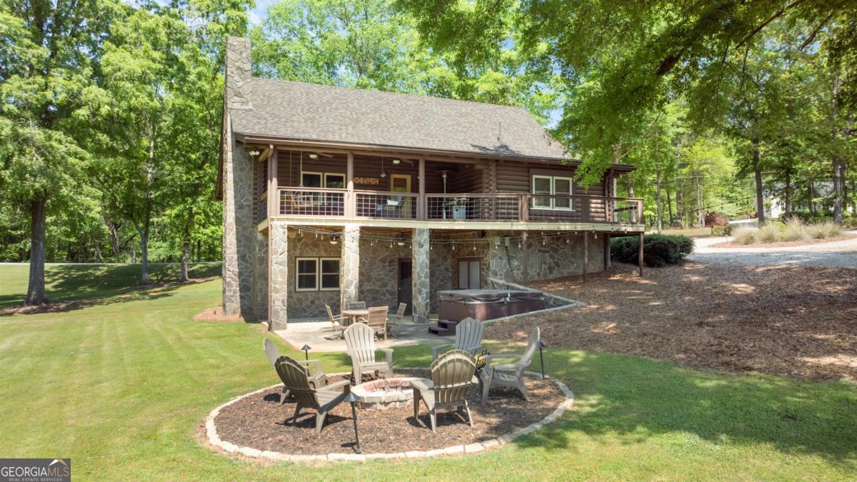 224 Loch Way Eatonton, GA 31024 - Photo 45 of 59 a backyard of a house with yard table and chairs