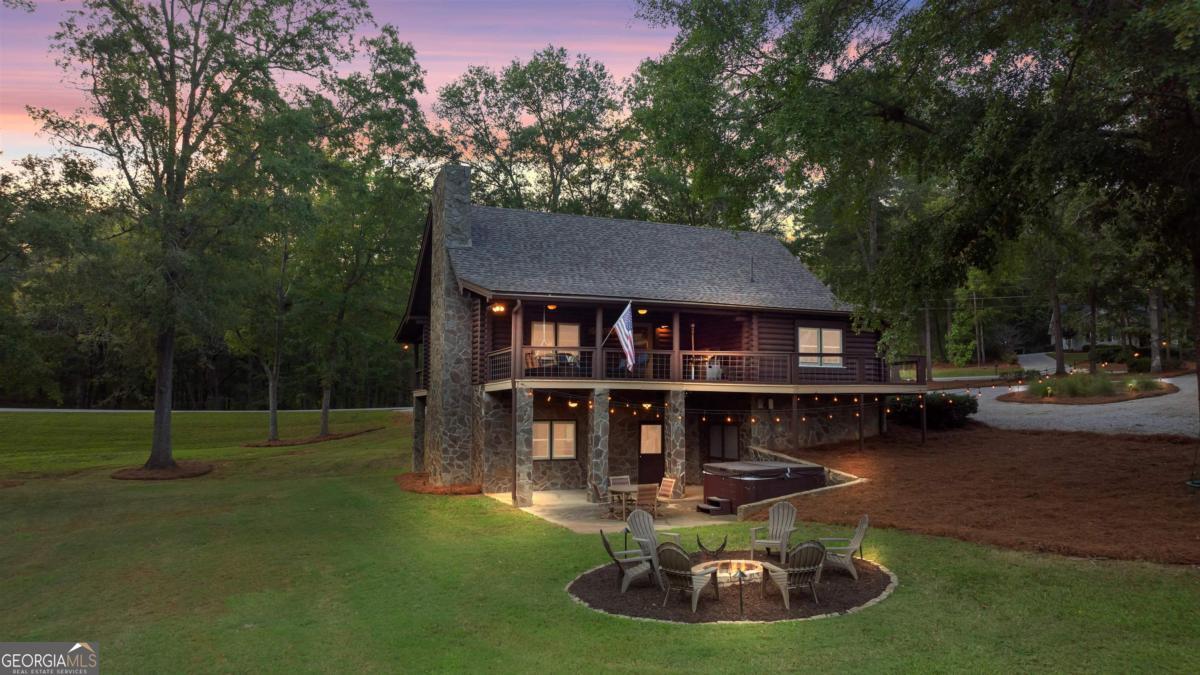 224 Loch Way Eatonton, GA 31024 - Photo 7 of 59 a view of house with swimming pool and sitting area