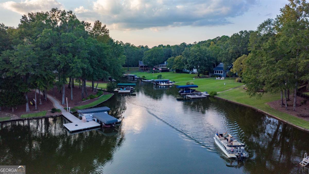 224 Loch Way Eatonton, GA 31024 - Photo 8 of 59 an aerial view of a house with swimming pool lake and outdoor seating