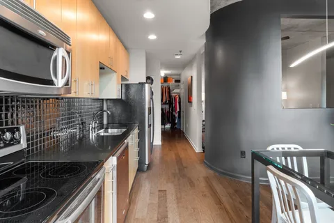 a kitchen with stainless steel appliances granite countertop a sink stove and cabinets