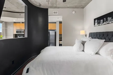 a bedroom with a bed and wooden floor