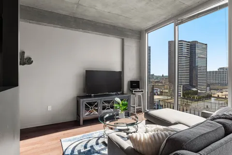a living room with furniture and a flat screen tv