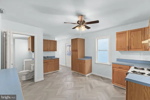 a living room with furniture a ceiling fan and a window