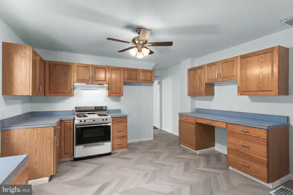 a kitchen with stainless steel appliances granite countertop a stove sink and cabinets