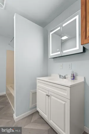 a utility room with cabinets washer and dryer