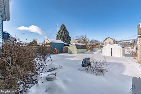 a front view of a house with a snow on the road