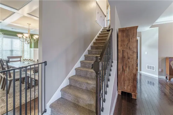 a view of entryway and hall with wooden floor