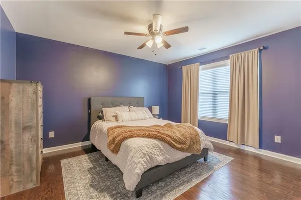 a bedroom with a large bed and a chandelier