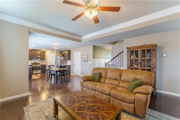 a living room with furniture and a dining table