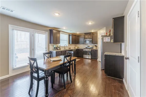 a view of a dining room with furniture and wooden floor