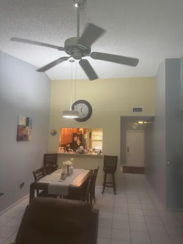 a room with furniture and a chandelier fan