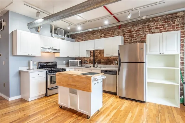 a kitchen with cabinets and stainless steel appliances