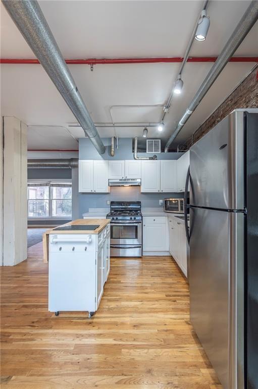 244 Peters Street Southwest, Unit 10 Atlanta, GA 30313 - Photo 13 of 38 a kitchen with stainless steel appliances granite countertop a refrigerator and a stove