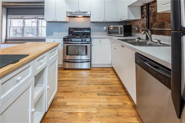 a kitchen with a sink stove and cabinets