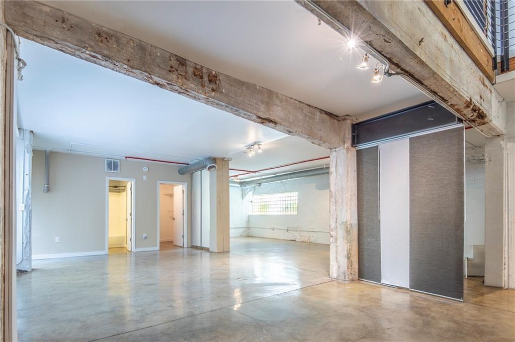 244 Peters Street Southwest, Unit 10 Atlanta, GA 30313 - Photo 20 of 38 a view of an empty room with wooden floor and a window