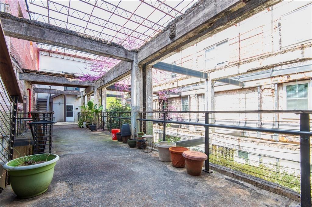 244 Peters Street Southwest, Unit 10 Atlanta, GA 30313 - Photo 2 of 38 a view of a backyard with table and chairs potted plants