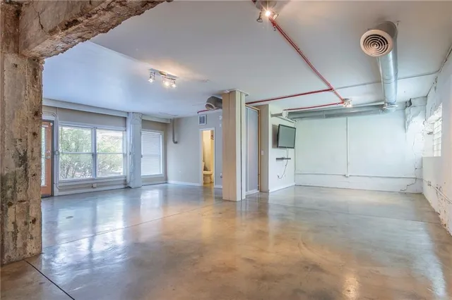 a view of a livingroom with wooden floor and a window
