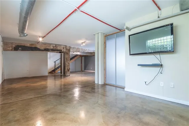 a view of a livingroom with wooden floor and a staircase