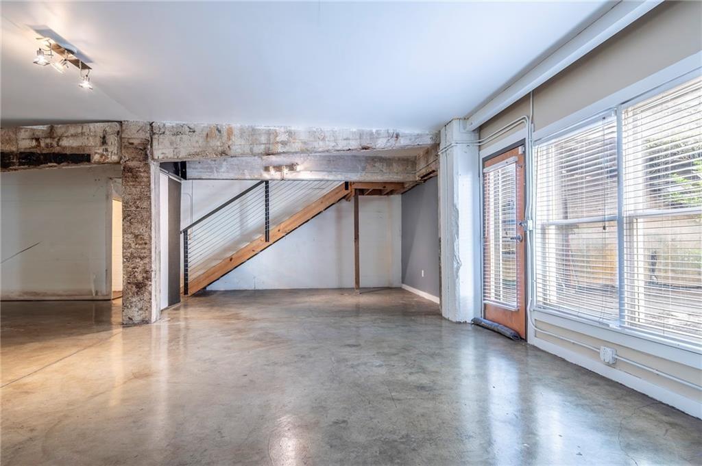 244 Peters Street Southwest, Unit 10 Atlanta, GA 30313 - Photo 25 of 38 an empty room with wooden floor and windows
