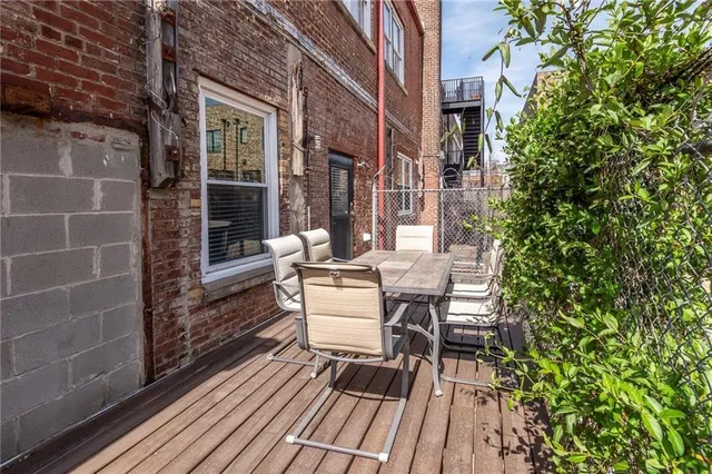 a view of a patio with table and chairs and potted plants