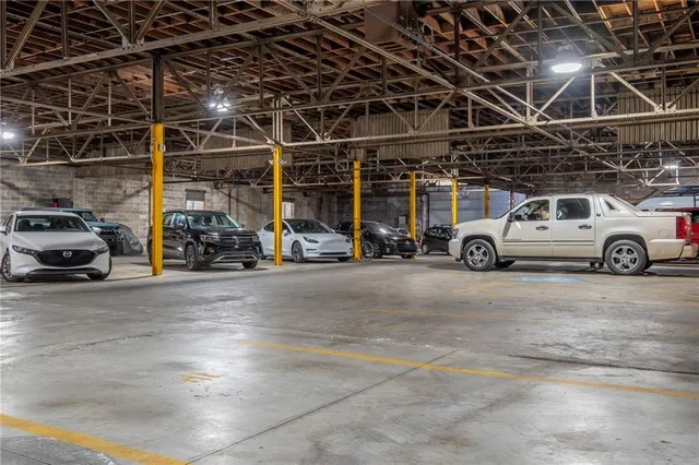 a view of parking space with lots of cars parked