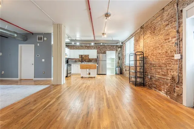 a big room with wooden floor and windows