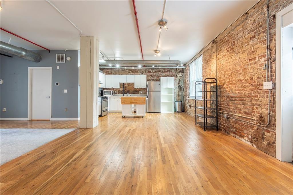 244 Peters Street Southwest, Unit 10 Atlanta, GA 30313 - Photo 9 of 38 a big room with wooden floor and windows